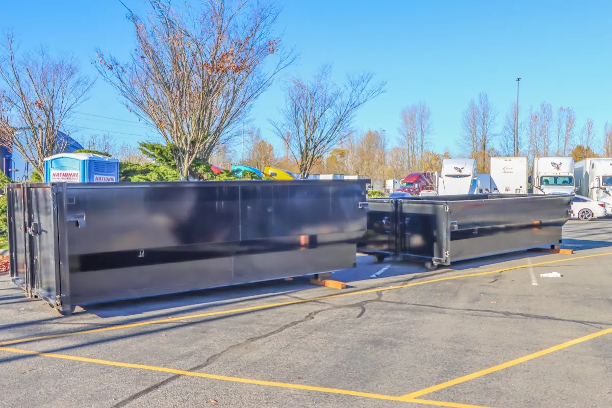 Professional dumpster rental service with roll-off container on residential driveway in Harper Woods
